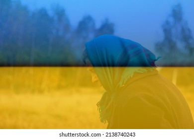 Defocus Portrait Of Russian Grandmother Senior Old Woman Standing In Yellow Autumn Park. Ukraine Ornament. Old Women In Coat And Shawl. Sad Person. Nature Background. Out Of Focus.