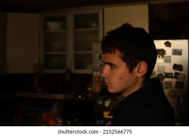 Defocus Portrait Of Young Man In Dark Kitchen. Millennial Dark Portrait. Mental Health. Crisis, Despair, Pain. Indoor. Unhappy Person. Out Of Focus.