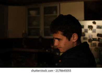 Defocus Portrait Of Young Man In Dark Kitchen. Millennial Dark Portrait. Mental Health. Crisis, Despair, Pain. Out Of Focus.