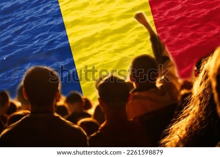 Defocus Romanian football team. supporters on stadium. Romania flag and football fans celebrating victory. Protest in Romania. Rise hand. Out of focus.