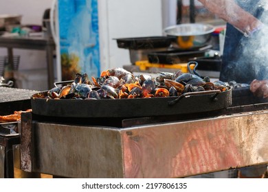 Defocus Seafood At Cooking Festival Outdoor. Seafood Paella. Chef Grilling Sausages In Park Outside. Concept Of Summer Party With Families And Friends. Out Of Focus.