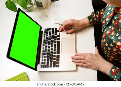 Defocus Woman Holding Pen And Working On Computer At Office. Laptop Green Screen. Start Or Finish Of A Work Day. Workspace. Paperwork. Time For Work. Closeup Businesswoman. Out Of Focus.