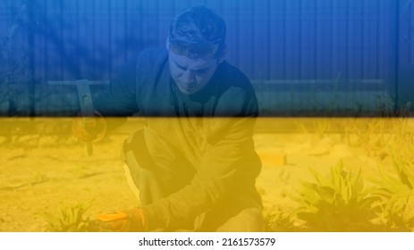 Defocus Young Construction Worker In Yellow Glasses Removing Irregularities On Floor Screed With Hammer And Chisel. Male Hands The Concrete Slab. Patio At Home. Rebuild Ukraine. Out Of Focus.