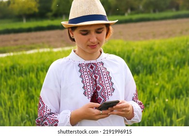 Defocus Young Ukrainian Woman Portrait. Meadow Nature Background. Sad Ukrainian Girl Scrolling Phone. Mental Health. Help Hotline. Reading News. Out Of Focus.