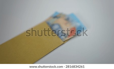 defocused abstrack background of brown envelope containing money 