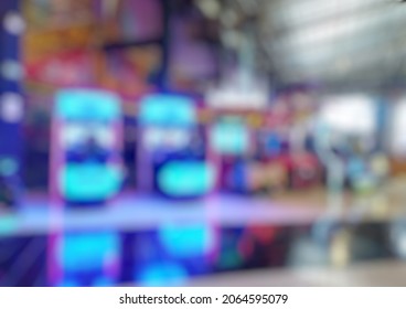 Defocused Abstract Background Of Arcade Game Machine Shop. Blurred Image Indoor Game Zone.