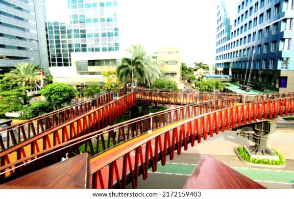 Defocused abstract background of beautiful\
pedestrian bridge. The design and color is very nice. Suitable for\
a place to relax, and take pictures. Located in the center of\
Jakarta, Indonesia.