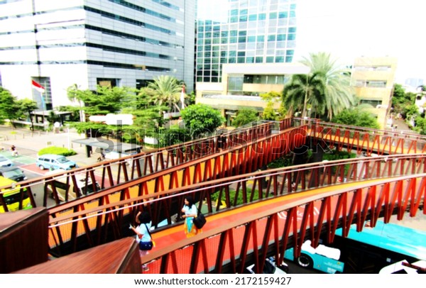 Defocused abstract background of beautiful\
pedestrian bridge. The design and color is very nice. Suitable for\
a place to relax, and take pictures. Located in the center of\
Jakarta, Indonesia.