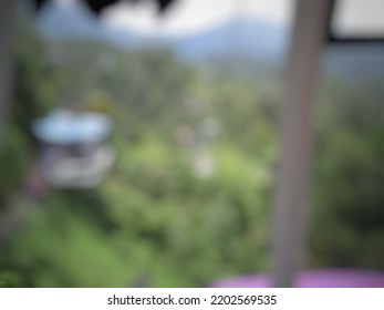 Defocused Abstract Background Of A Beautiful View From Inside A Cable Car, Forest Trees View From Above, Natural Light. Abstract Blurred Background.