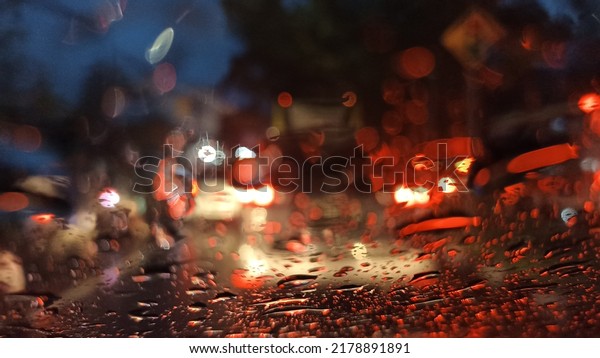 defocused abstract background of blurry vision in\
the car\'s window, made by pouring rain that fallin\' while the\
traffic stuck