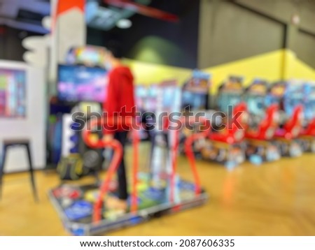 Defocused abstract background of boy playing game in Old Vintage Arcade game zone. 
