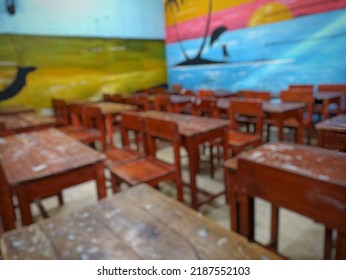 Defocused Abstract Background Of An Empty Elementary Classroom With A Landscape Painting Background