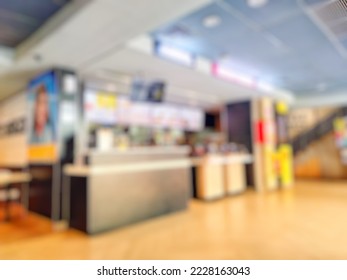 Defocused abstract background of Empty Fast food Restaurant counter inside modern shopping mall or shopping center. Bokeh fast food restaurant interior with vintage tone effect image 