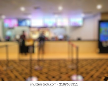 Defocused Abstract Background Of Movie Theater Lobby. Bokeh Images Of Places For Ordering Ticket, Popcorn And Drinks In Cinema, With Warm Vintage Tone Effect. 