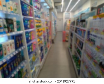 Defocused Abstract Background. Pharmacy Aisle With Products Unrecognizable By The Blur. For The Background. Empty Pharmacy Aisle