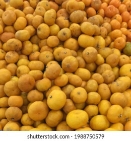 Defocused Abstract Background Of Pile Mandarin Oranges, Blur Of Pile Small Oranges