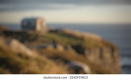 Defocused abstract background of a rustic cabin above the sea at sunset, capturing natural textures of grass, rocks, and endless ocean horizon. - Powered by Shutterstock