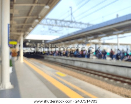 Defocused abstract background, train passengers at the station are waiting for the train