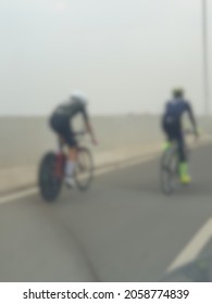 Defocused abstract background of two persons on bicycle