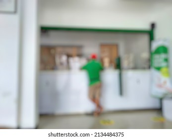 Defocused Abstract background of Typical Indonesia pawnshop Interior. Bokeh image inside pawnshop with customer at the counter.