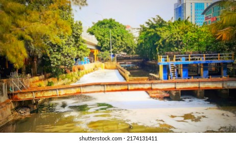 Defocused Abstract Background Of A View Of The River, Which Is Covered In White Foam, Or Wastewater. Located In West Jakarta, Indonesia.