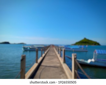 Defocused abstract background of water droplets on jetty and boat