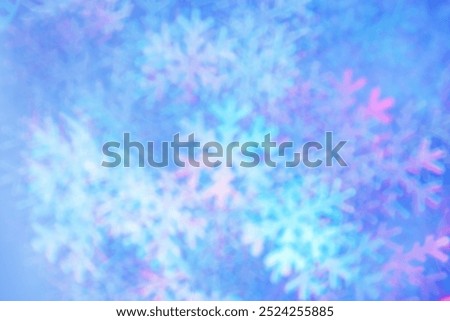 Defocused abstract figured bokeh background, flare from lights as snowflakes, blurred snowflake bokeh as winter holiday texture. Creative New Year aesthetic textured lighting pattern for festive