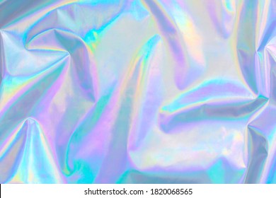 De-focused abstract Modern pastel colored holographic background in 80s style. Crumpled iridescent foil textile real texture. Synthwave. Vaporwave style. Retrowave, retro futurism, webpunk