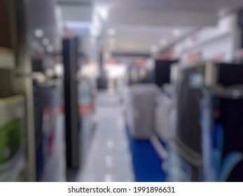 Defocused Background Of Aisle Showing Refrigrator, Washing Machine And Television. Blurred Image Row Of Household Appliances At Electronic Store In Indonesia 