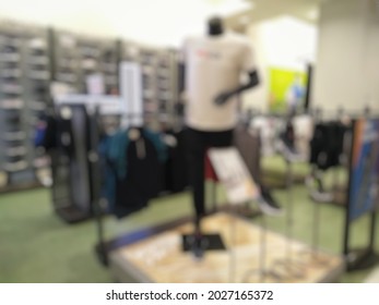 Defocused Background Corner Of Sports Fashion In Department Store. Mannequins Are Dressed In Sport Collection Clothes. 