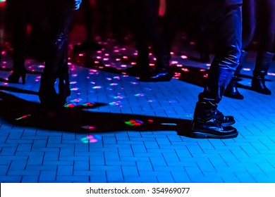 Defocused Background Of A Dance Floor In A Disco Club With People Dancing Under The Disco Ball Blue Lights