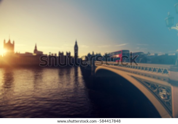 Defocused background of London\
traffic near Big Ben of Westminster in rush hour in the\
sunset.
