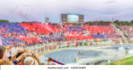 Defocused background with supporters in the stadium for football match. Intentionally blurred post production for bokeh effect - Shutterstock ID 1204554409