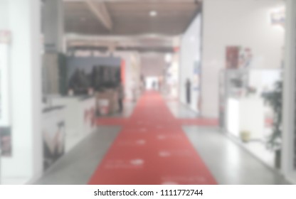 Defocused background of a trade show with people visiting the commercial exhibition. Intentionally blurred post production for bokeh effect - Shutterstock ID 1111772744