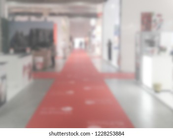 Defocused background of a trade show with people visiting the commercial exhibition. Intentionally blurred post production for bokeh effect - Shutterstock ID 1228253884