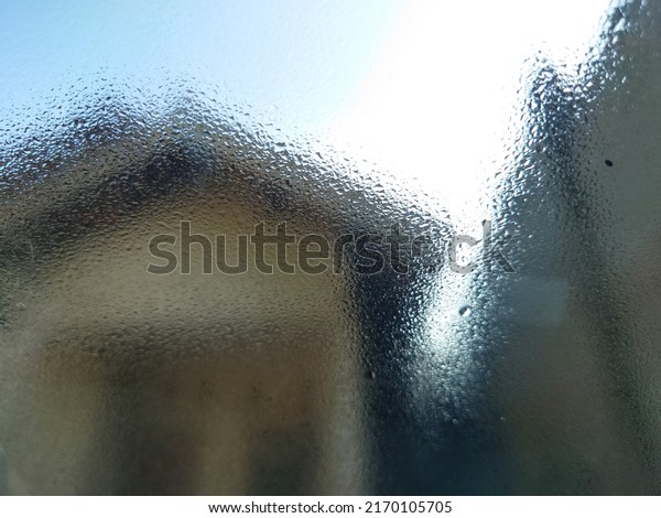 defocused background view of home with water drop\
in car window