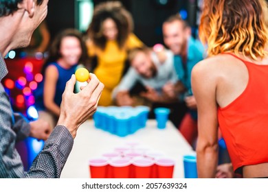 Defocused background of young friends playing beer pong at youth hostel - Free time travel concept with backpackers having genuine fun at guesthouse - Blurred view of happy people on playful attitude