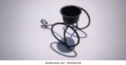 Defocused Of A Black Candle Holder With The Shadow