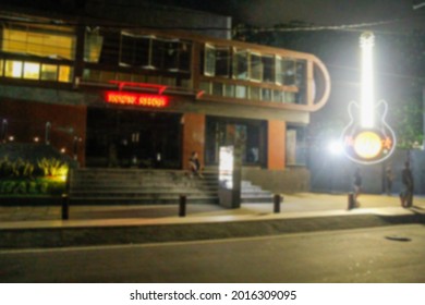 Defocused blur image of roadside shops at night