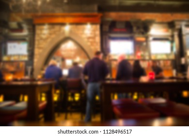 Defocused Blur From Irish Pub With Unrecognizable People At The Bar.