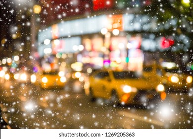 Defocused blur New York City  Manhattan street scene with yellow taxi cabs and snowflakes falling during winter snow storm - Powered by Shutterstock