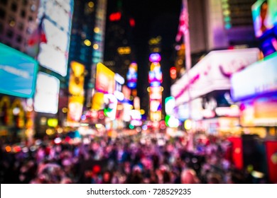 Defocused Blur Of Times Square In New York City, Midtown Manhattan At Night With Lights And People.