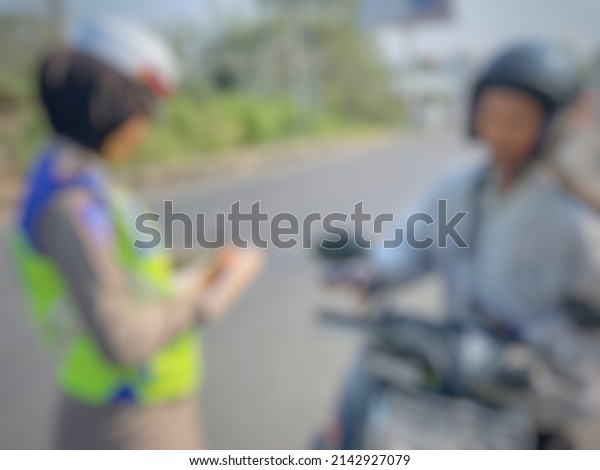defocused blur The traffic police are checking\
motorcycle riders on the\
streets.