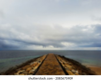 Defocused blurred abstract background of the path to the sea when the weather is cloudy