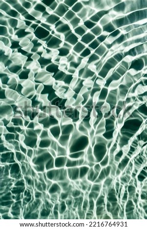 Defocused blurred background transparent fresh blue green water gel surface with flecks, waves, shade. Healthy relaxation in sunny summer. Vacation spa coast, natural concept. Vertical. Place for text