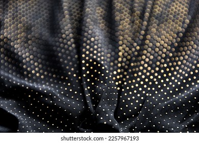 Defocused blurred golden polka dot pattern on black folded fabric as background - Shutterstock ID 2257967193