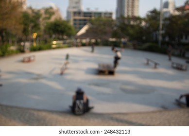 Defocused and blurred image for background of boy skating on skateboard in skate park 
