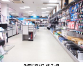 Defocused and blurred interior electronics store, with long shelves with goods. the image was blurred for use as a background