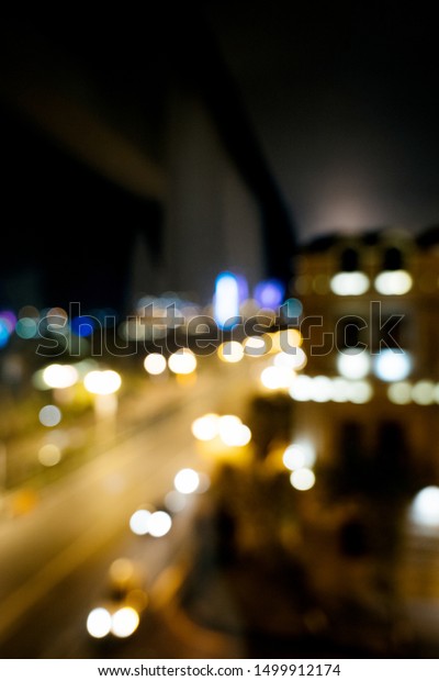 Defocused\
blurred lights of Baku city at night - main avenue with multiple\
cars driving fast - tilt-shift lens\
used