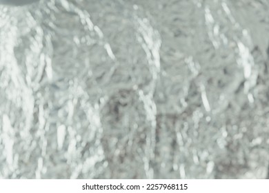 Defocused blurred silver foil as texture background and wrapping material - Shutterstock ID 2257968115